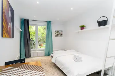 a bedroom with two bunk beds and a window at Park Krakowski Homely Studio with Garden by BookingHost in Kraków