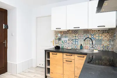 a kitchen with a sink and a counter top at Park Krakowski Homely Studio with Garden by BookingHost in Kraków