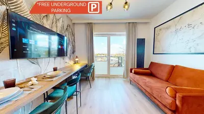 a living room with a couch and a table at Apartamenty na Pana Tadeusza in Kraków