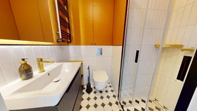 a bathroom with a sink and a shower and a toilet at Apartamenty na Pana Tadeusza in Kraków