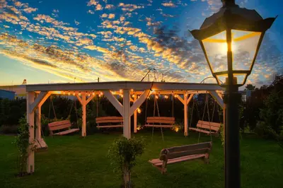 a gazebo with benches and a street light at Skandynawia Przystań & Family Resort in Zator