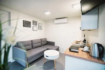 a living room with a couch and a table at Skandynawia Przystań & Family Resort in Zator