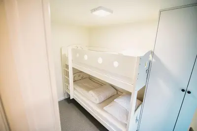a small closet with white shelves and a mirror at Skandynawia Przystań & Family Resort in Zator
