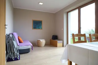 a living room with a table and chairs and a window at Las Góra Natura in Laskowa