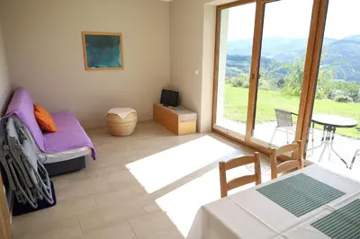a room with a bed and a table and a window at Las Góra Natura in Laskowa