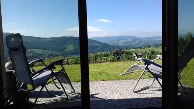 two chairs sitting in front of a window at Las Góra Natura in Laskowa