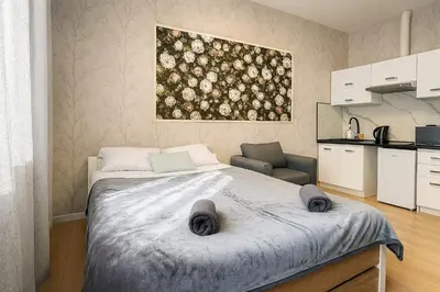 a bedroom with a bed and a painting on the wall at Apart HOSTEL - KrakHouse in Kraków