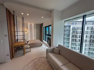 a living room with a couch and a bedroom at Aga Apartments Cracow Old Town in Kraków