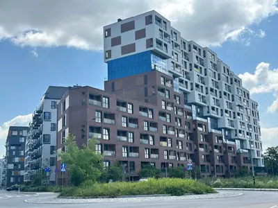 a tall apartment building in front of a street at Aga Apartments Cracow Old Town in Kraków