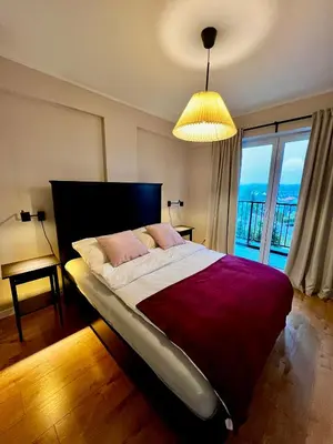 a bedroom with a large bed with a large window at Apartament Gucio in Zator
