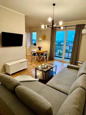 a living room with a couch and a tv at Apartament Gucio in Zator