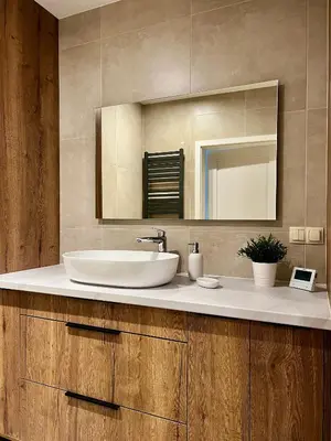 a bathroom with a sink and a mirror at Apartament Gucio in Zator