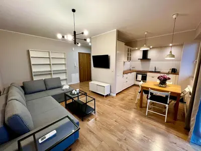 a living room and kitchen with a couch and a table at Apartament Gucio in Zator