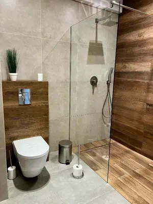 a bathroom with a toilet and a shower at Apartament Gucio in Zator