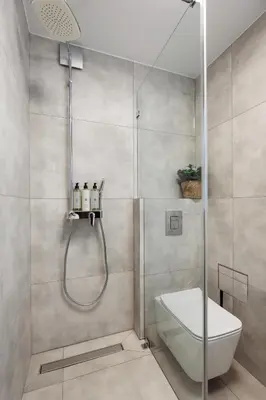 a bathroom with a shower with a toilet and a sink at Monika Apartments by Upstairs in Kraków