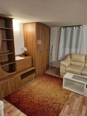 a living room with a couch and a chair at Pokoj u Eleni #2 in Kraków