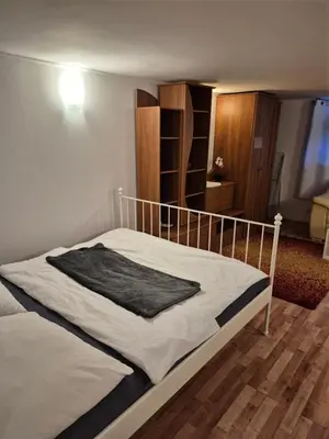 a bed with a black blanket on top of it at Pokoj u Eleni #2 in Kraków