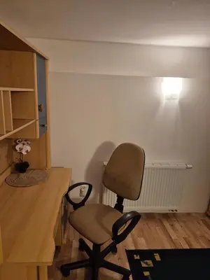 a desk and a chair in a room at Pokoj u Eleni #1 in Kraków