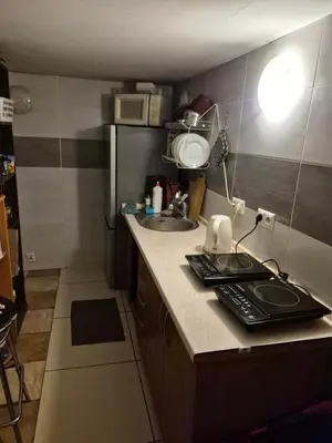 a small kitchen with a sink and a refrigerator at Pokoj u Eleni #1 in Kraków