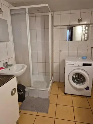 a bathroom with a washing machine and a sink at Pokoj u Eleni #1 in Kraków
