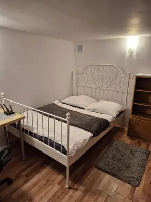 a white bed in a room with a desk at Pokoj u Eleni #5 in Kraków