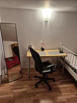 a desk with a mirror and a chair in a room at Pokoj u Eleni #5 in Kraków