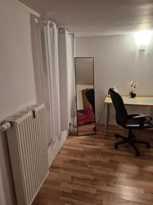an office with a desk and a chair and a mirror at Pokoj u Eleni #5 in Kraków