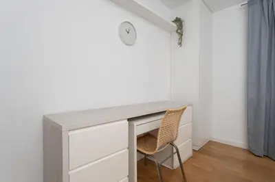 a living room with two couches and a kitchen at Wilga Park Homely Apartment by BookingHost in Kraków