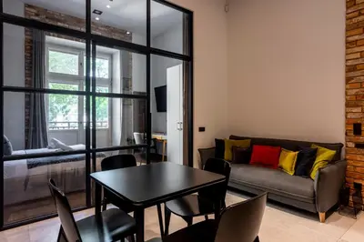 a living room with a table and a couch at Tyzenhauz Apartments Superior in Kraków