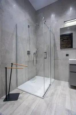 a bathroom with a shower with a glass door at Tyzenhauz Apartments Superior in Kraków