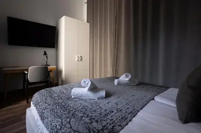 a bedroom with a bed with towels on it at Tyzenhauz Apartments Superior in Kraków