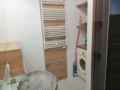 a laundry room with a washer and a washing machine at Fajny Apartament EXPO TAURON ARENA in Kraków