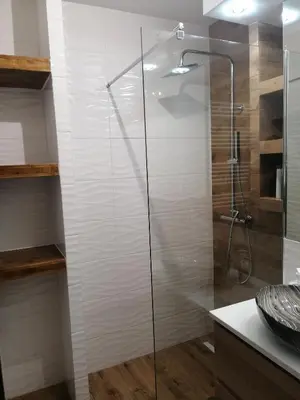 a shower with a glass door in a bathroom at Fajny Apartament EXPO TAURON ARENA in Kraków
