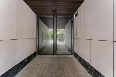 an entrance to a building with a metal gate at Kościuszki Chic Studio with Garden by BookingHost in Kraków
