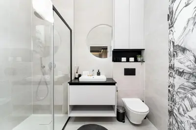 a white bathroom with a sink and a toilet at Kościuszki Chic Studio with Garden by BookingHost in Kraków