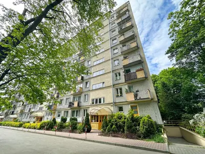 a tall apartment building on a city street at Vista Kraków Ugorek in Kraków