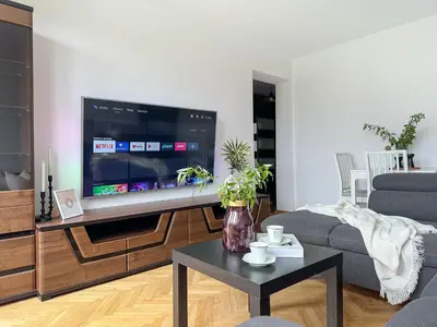 a living room with a large flat screen tv at Vista Kraków Ugorek in Kraków