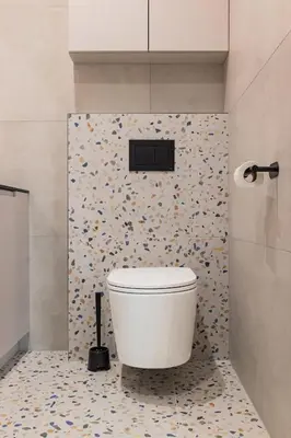 a white toilet in a bathroom with flowers on the wall at Między Wawelem a Rynkiem in Kraków