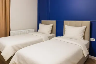 two beds sitting next to each other in a room at Między Wawelem a Rynkiem in Kraków