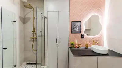 a bathroom with a sink and a shower at Między Wawelem a Rynkiem in Kraków