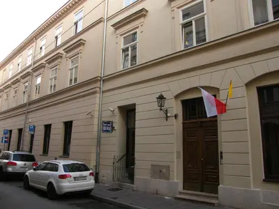 a building with a flag on the side of it at Apartament Jagielloński in Kraków