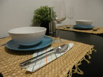a table with a bowl and a plate and spoon and glasses at Apartament Jagielloński in Kraków