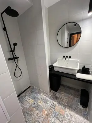 a bathroom with a sink and a mirror at CracoviaStay Lofty Apartment Old Town Kazimierz Historic Heart of Krakow in Kraków