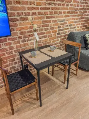 a table with two chairs and a table with two cups at CracoviaStay Lofty Apartment Old Town Kazimierz Historic Heart of Krakow in Kraków