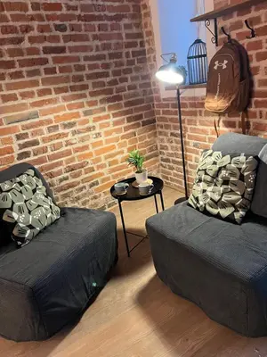 a room with two beds and a brick wall at CracoviaStay Lofty Apartment Old Town Kazimierz Historic Heart of Krakow in Kraków