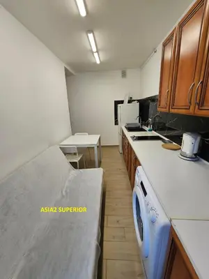 a kitchen with a sink and a stove top oven at Apartamenty Asia Kraków in Kraków