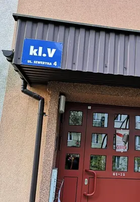 a sign on the side of a building with a door at Apartamenty Asia Kraków in Kraków