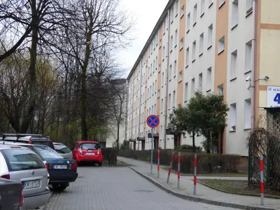 a street with cars parked next to a building at Apartamenty Asia Kraków in Kraków