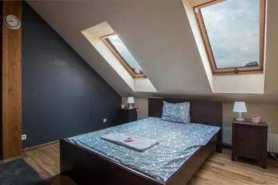 a bed in a room with two skylights at Spacious house in the rural suburbs of Krakow in Zagacie