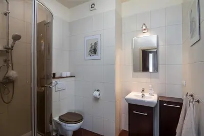 a bathroom with a toilet and a sink and a shower at Spacious house in the rural suburbs of Krakow in Zagacie